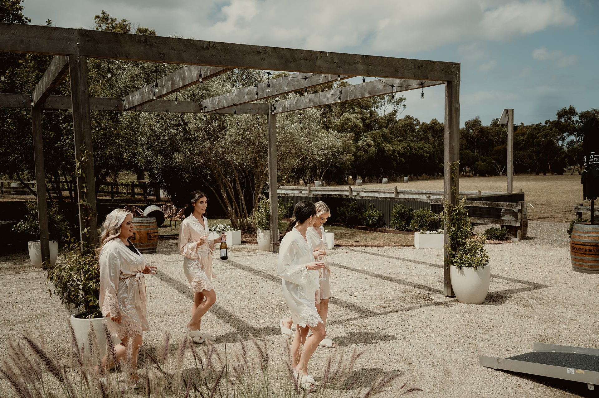 Bridesmaids enjoying champagne outside the Bridal Retreat at Scotchmans Hill winery before the wedding ceremony.
