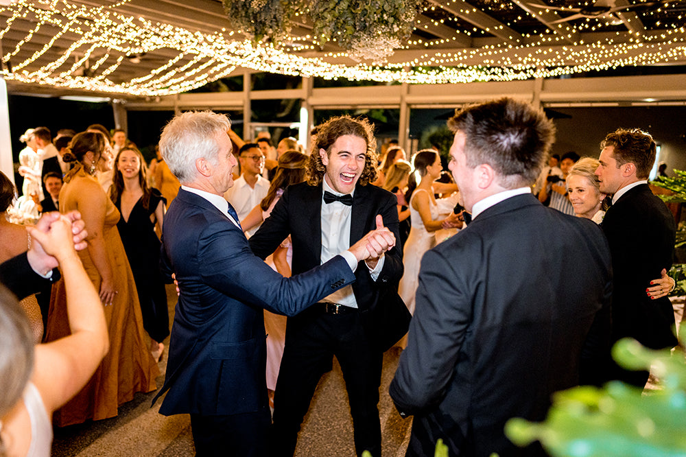 Wedding guests dancing and celebrating under fairy lights at Scotchmans Hill reception.