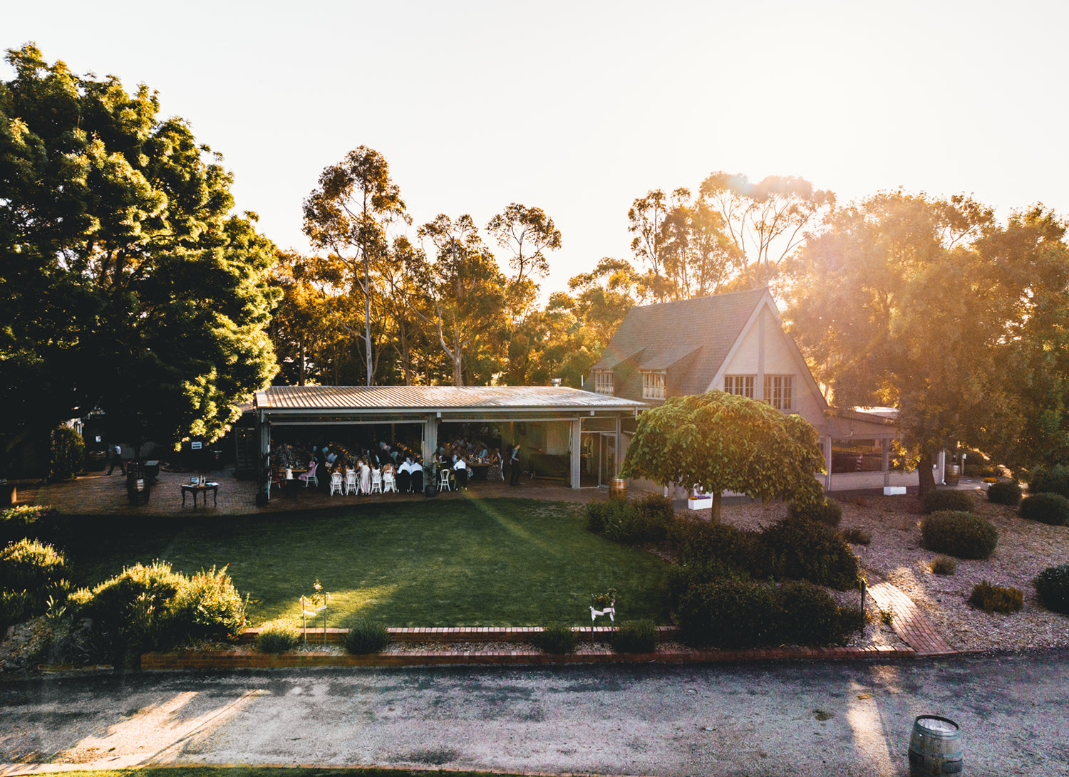 Aerial view of the restaurant at Scotchmans Hill on the Bellarine Peninsula, showcasing outdoor vineyard dining surrounded by trees at sunset.