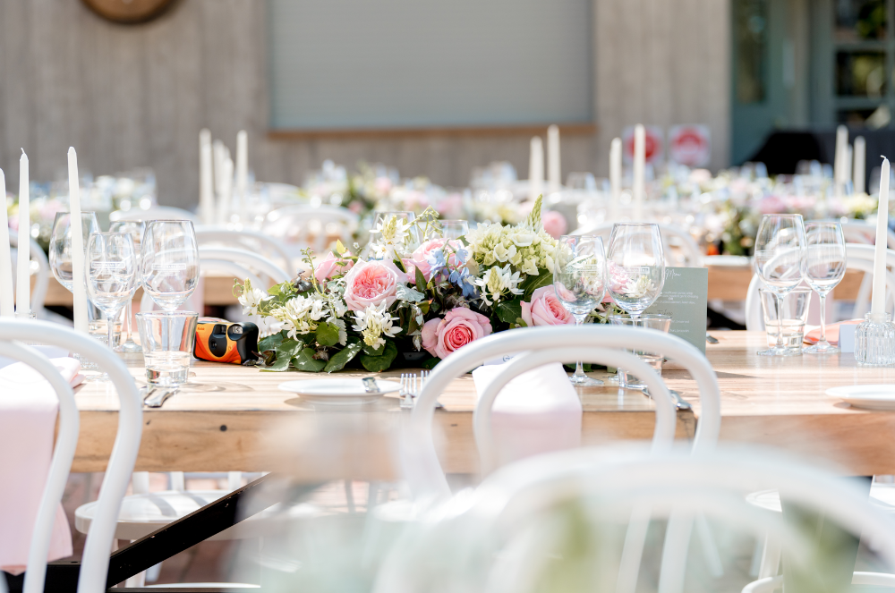 Elegant winery wedding table setting with pink and white floral centrepieces at Scotchmans Hill on the Bellarine Peninsula.